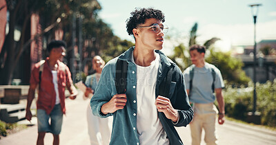Buy stock photo Education, man and walking with student friends outdoor together for learning or study at university campus. College, future and thinking with learner group at school for knowledge or scholarship