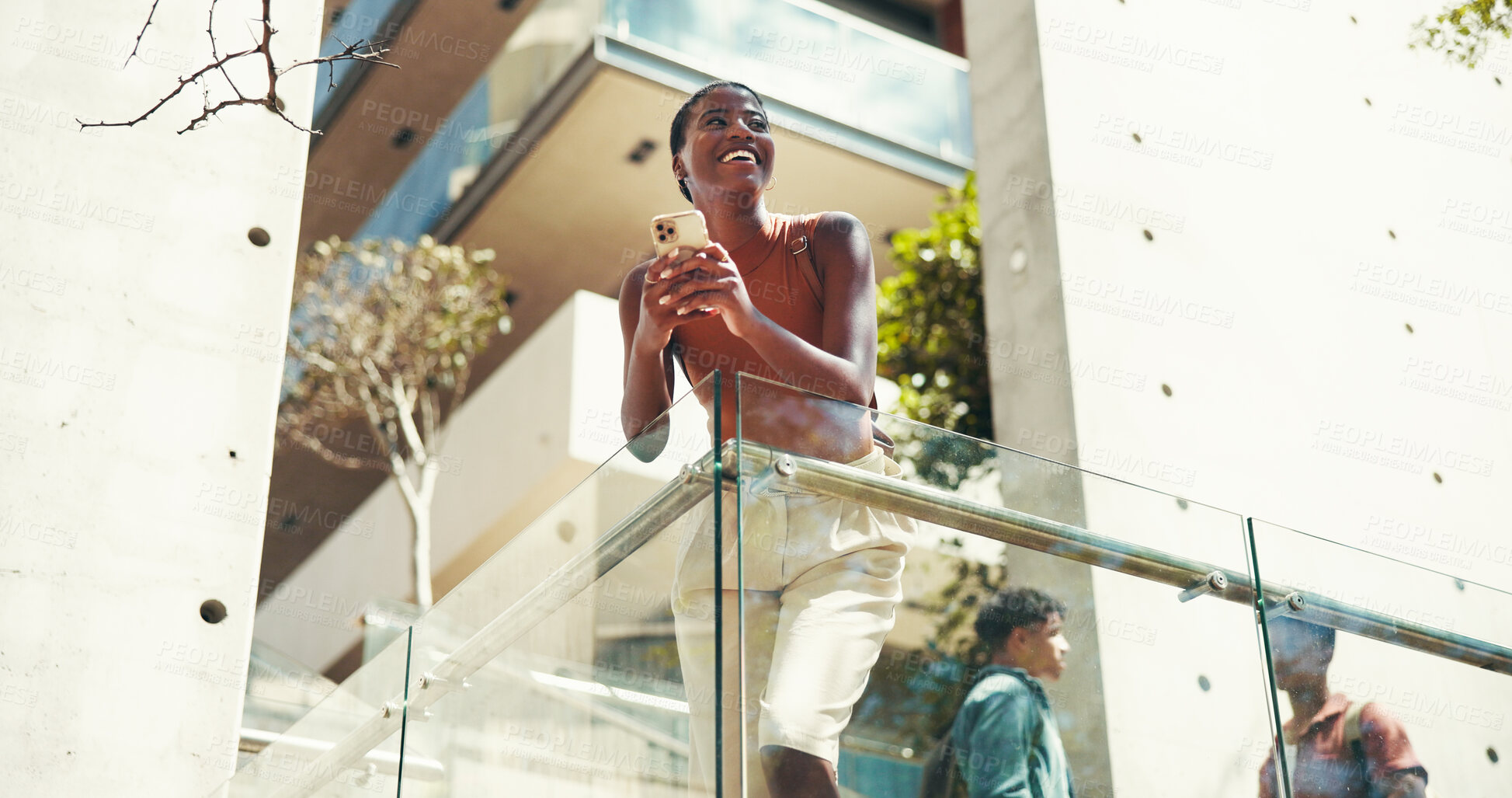 Buy stock photo Woman, student and phone on stairs at college, smile or thinking with class schedule in low angle. African girl, smartphone and happy with mobile app on steps, texting and social media at university