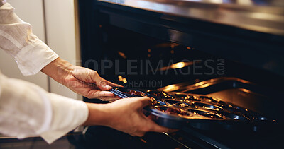 Buy stock photo Hands, person and muffins in oven for baking as Christmas dessert, cake and meal prep at kitchen. Closeup, baker and chef at home with culinary skills or talent for delight snack, cupcakes and pastry