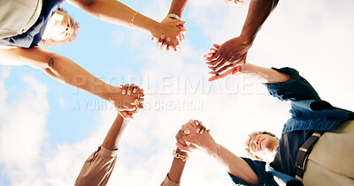 Buy stock photo Friends, people and holding hands outdoor for teamwork, synergy or solidarity by sky. Group, support and community of students in circle for cooperation, association or collaboration at college below