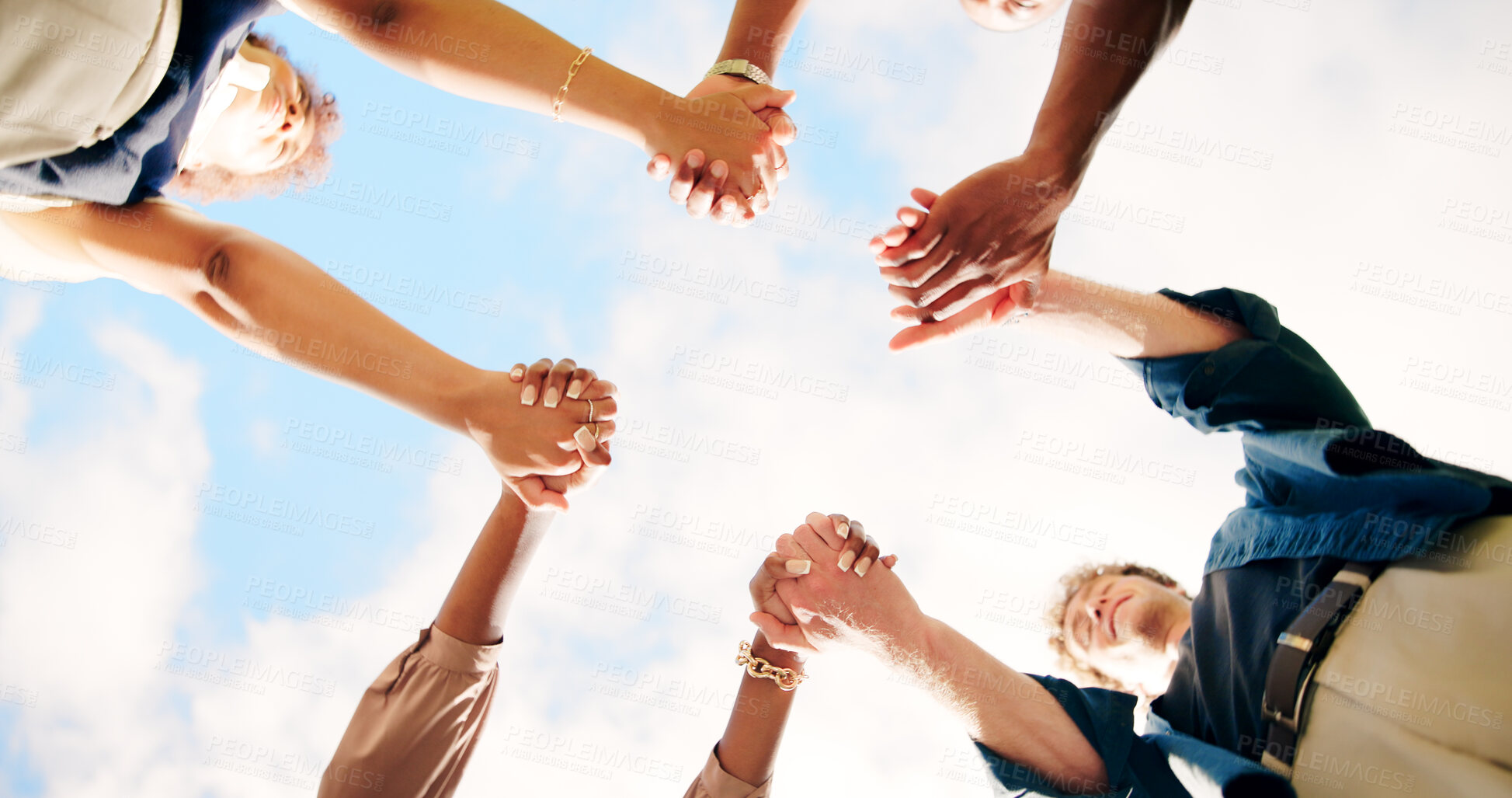 Buy stock photo Friends, people and holding hands outdoor for teamwork, synergy or solidarity by sky. Group, support and community of students in circle for cooperation, association or collaboration at college below