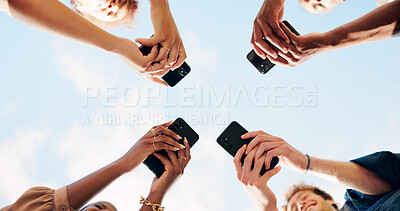 Buy stock photo People, hands and phone below with circle for data sync, share or network connectivity under blue sky background. Low angle, friends or group with mobile smartphone for online software, app or UX