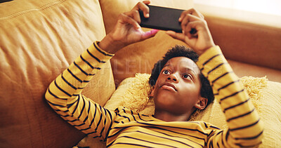 Buy stock photo African child, streaming and smartphone for relax, development and educational games as online. Kid, mobile technology and home with creativity, fun and social media for application, download or play