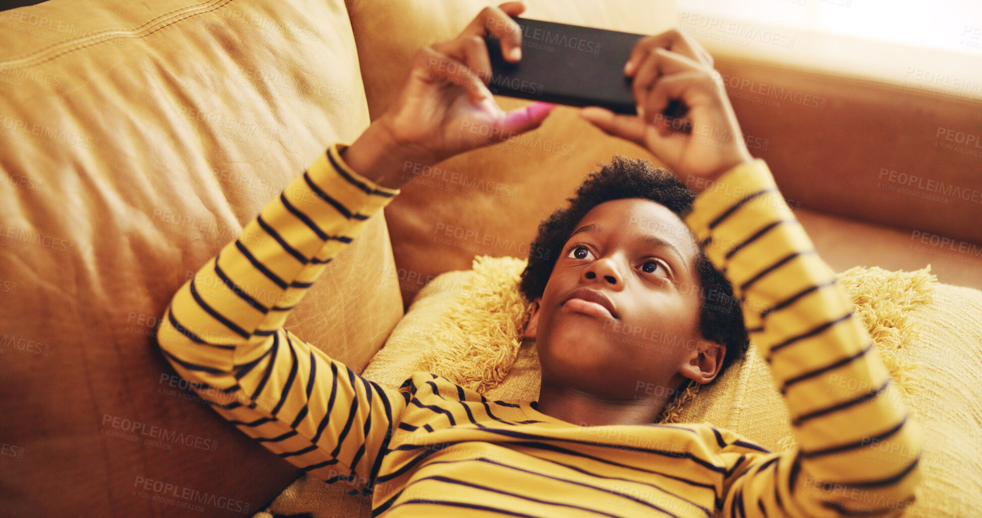 Buy stock photo African child, streaming and smartphone for relax, development and educational games as online. Kid, mobile technology and home with creativity, fun and social media for application, download or play