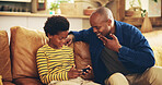 Bonding, dad and child with smartphone, gaming and man with gesture for boy, playing and fun for score. House, father and gamer with mobile app in lounge, African and sign language for deaf kid