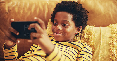 Buy stock photo African child, streaming and smartphone for educational games, growth and development in home. Kid, mobile tech and esports for creativity, fun and social media with application, download and playing