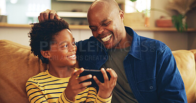 Buy stock photo Playing, dad and child with smartphone, home and bonding with video game, laughing and fun for score. House, man and gamer with mobile app in lounge, African and boy with hobby, subscription or break