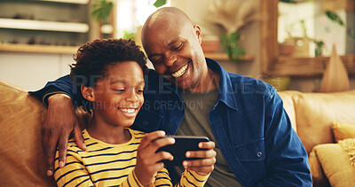 Buy stock photo Laughing, dad and child with smartphone, home and bonding with video game, playing and fun for score. House, man and gamer with mobile app in lounge, African and boy with hobby, subscription or break
