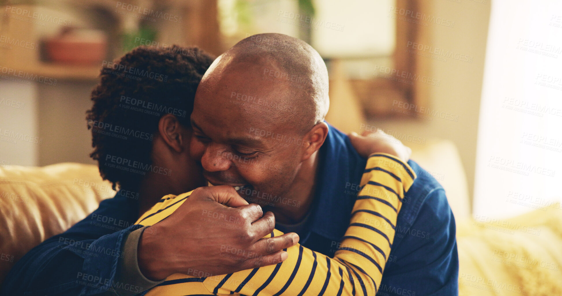 Buy stock photo Bonding, hug or love with dad and son on sofa in living room of home together for development. Black family, happy or support with boy child and single parent man embracing in apartment for caring