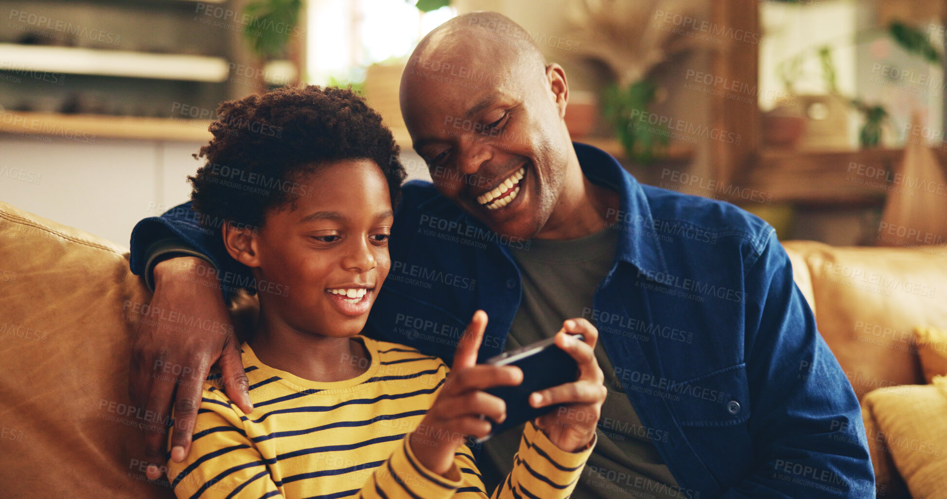 Buy stock photo Fun, dad and child with smartphone, home and bonding with video game, laughing and playing for score. House, man and gamer with mobile app in lounge, African and boy with hobby, subscription or break