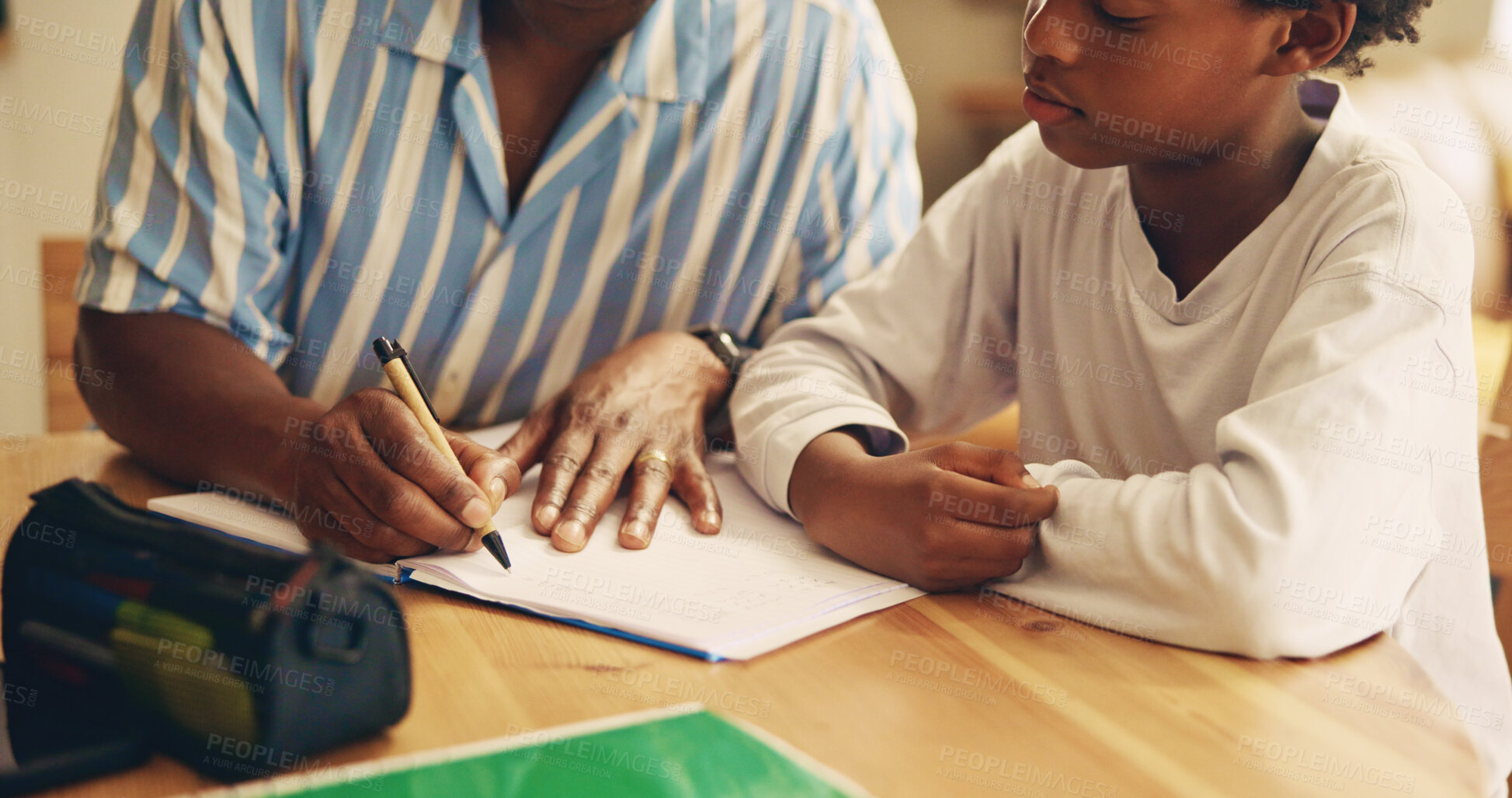 Buy stock photo Table, studying and child with dad, hands and support for son, growth and development with education. Bonding, man and help for homework, writing and kid with knowledge, notebook and teaching in home