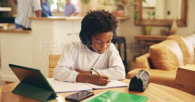 Buy stock photo Studying, education and child with headphones, writing and preparing for exam, African and serious. Home, online and practice for test, growth and development with podcast, boy or audio for knowledge