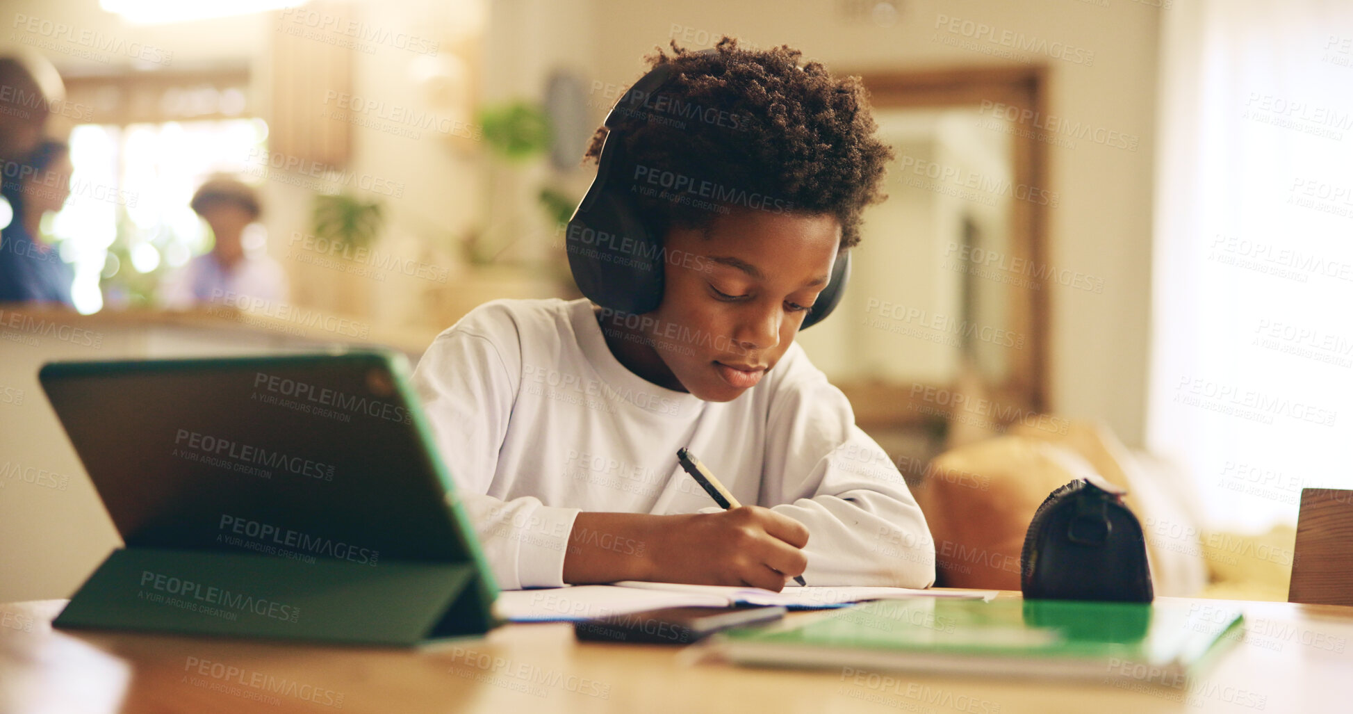 Buy stock photo Serious, knowledge and child with headphones, writing and preparing for exam, growth and development for kid. Home, audio and practice for test, listening and podcast for education, African and tech