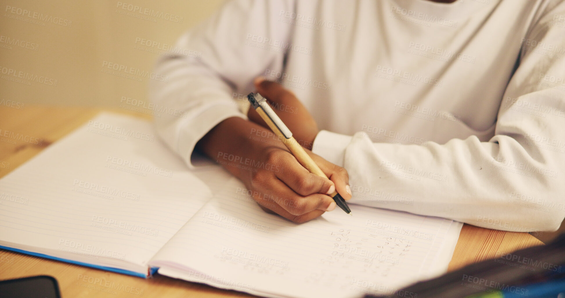 Buy stock photo Hands, writing and child with notebook, desk and education for student, growth and development in school. Table, pupil and kid with assessment, closeup and youth with scholarship in classroom