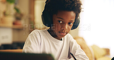 Buy stock photo Video, home and child with headphones, tablet and boy with information, education and studying for exam. Desk, growth and development of African kid, listening and podcast for knowledge at house