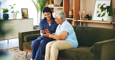 Buy stock photo Help, phone and old woman on couch with nurse for senior care, support and smile in lounge at home. Homecare, elderly person and caregiver on sofa with smartphone, healthcare and mobile app advice