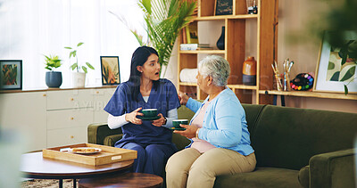 Buy stock photo Senior woman, surprised nurse and tea in home for retirement support, conversation and listening to story. Old person, caregiver and shocked with beverage in morning for relax, service and wellness