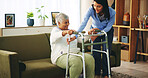 Elderly woman, walker and caregiver in home for help, assisted living and rehabilitation. Senior person with disability, volunteer and frame in lounge for balance, support and mobility in retirement