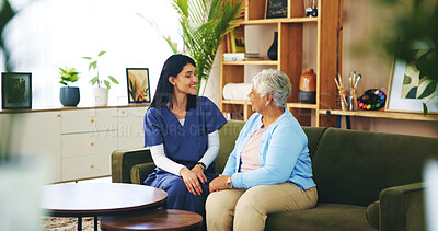 Buy stock photo Smile, conversation and old woman on sofa with caregiver for senior care, support and trust in lounge at home. Homecare, elderly person and nurse on couch with healthcare advice, bonding and comfort