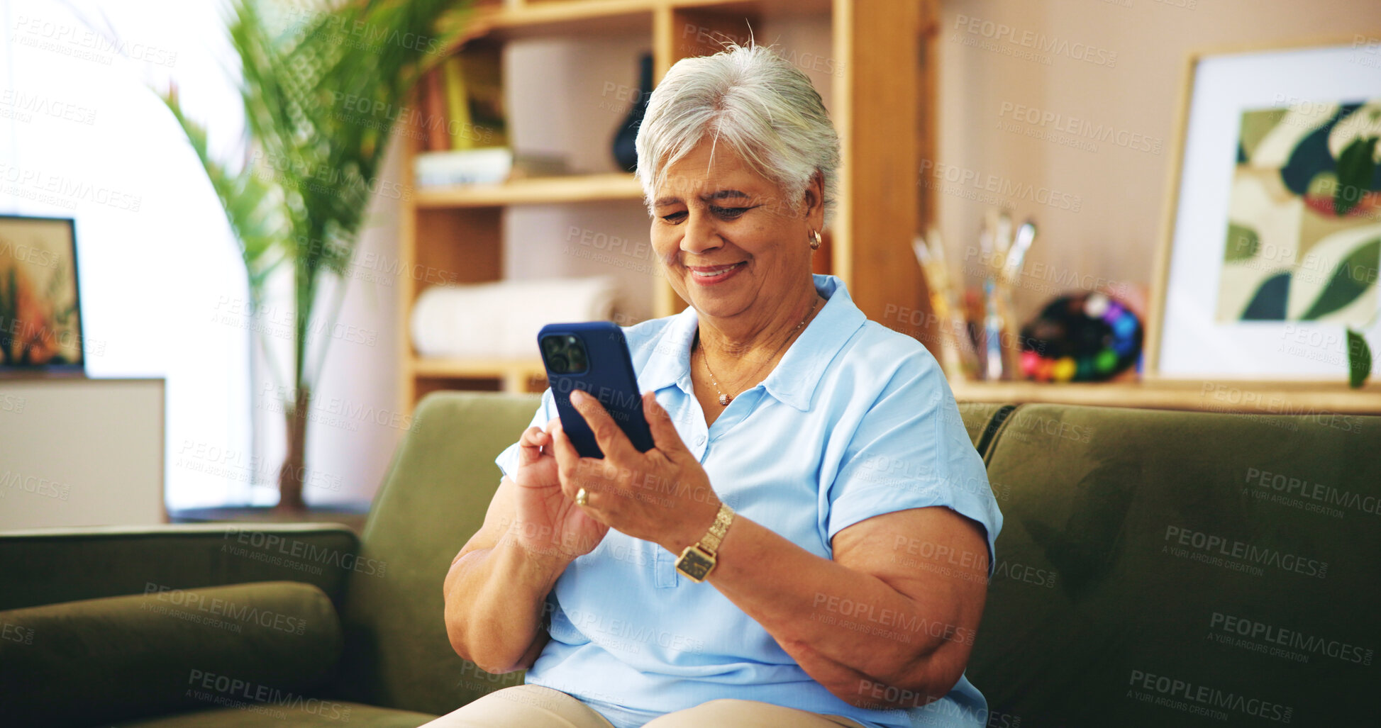 Buy stock photo Senior woman, happy and texting on sofa in home with chat, contact or scroll with connection on web. Elderly person, smartphone and smile on couch with click on mobile app for social media in house