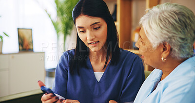 Buy stock photo Showing, phone and old woman on sofa with nurse for senior care, support and learning in lounge at home. Homecare, elderly person and caregiver on couch with smartphone, healthcare or mobile app help