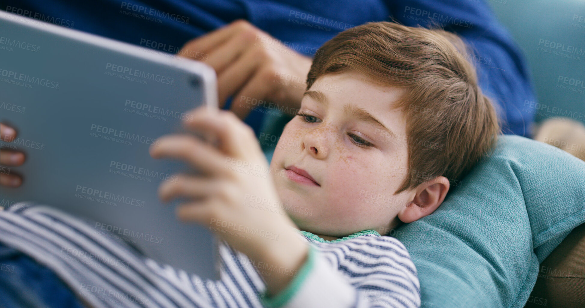 Buy stock photo Child, tablet and relax in home with movie, entertainment or interactive game with parent. Boy kid, tech or app in living room for streaming platform, cartoon and online media in subscription service