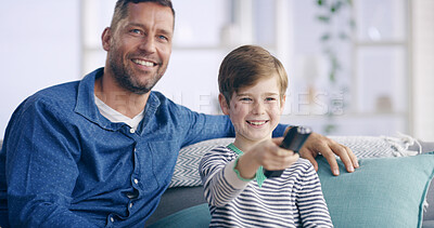 Buy stock photo Dad, boy and watching tv with remote on couch, relax and smile in living room at family house. Father, child and happy together on sofa for streaming, video and cartoon movies with bonding in home