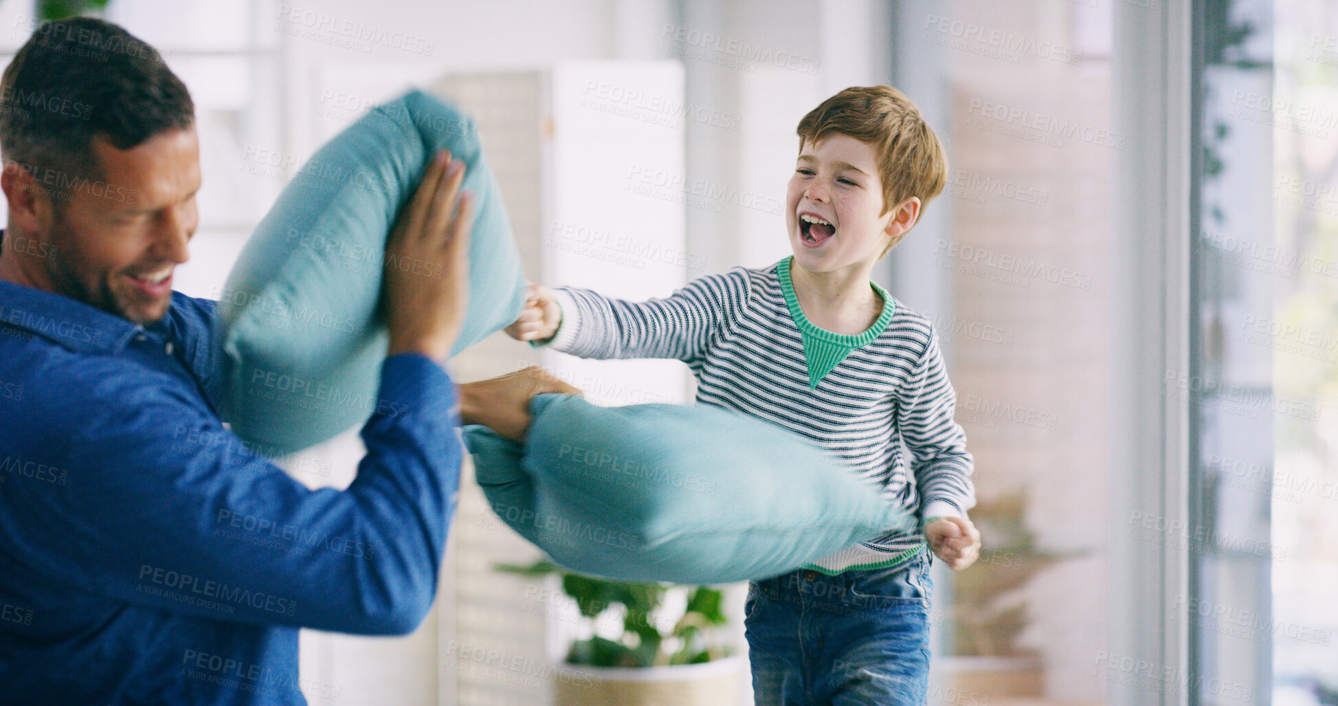 Buy stock photo Boy, father and pillow fight with laughing in home for conflict, games and excited for bonding in living room. Child, dad and smile with cushion, happy and connection with challenge in family house