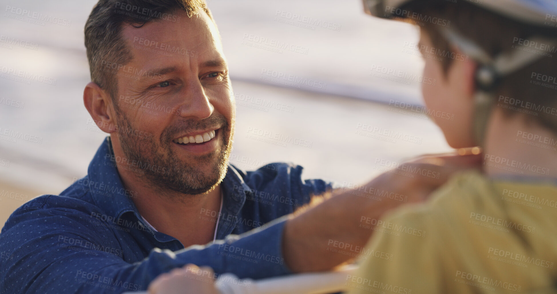 Buy stock photo Happy dad, child and helmet with help for protection, learning or teaching son to ride a bike in neighborhood. Parent, kid or boy with safety for cycling, bicycle lesson or practice at outdoor park