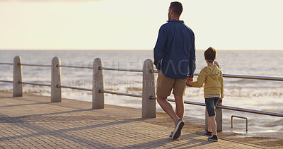 Buy stock photo Dad, son and holding hands at sea on holiday, walking and outdoor for bonding with father. Boy, child and papa for vacation security in relationship, together and ocean for love or care on trip