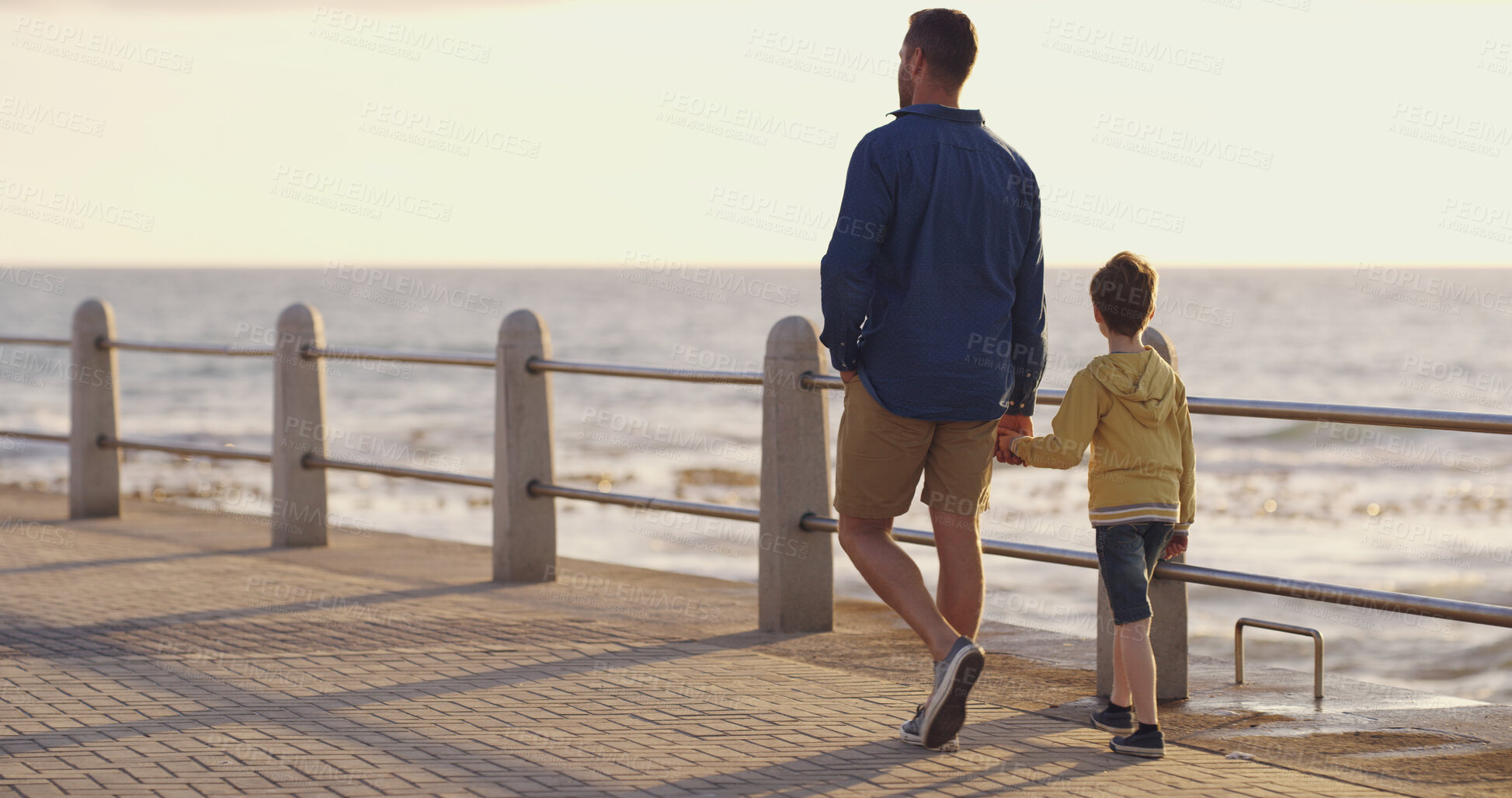Buy stock photo Dad, son and holding hands at sea on holiday, walking and outdoor for bonding with father. Boy, child and papa for vacation security in relationship, together and ocean for love or care on trip