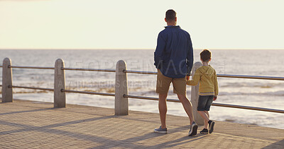 Buy stock photo Dad, son and holding hands at beach on holiday, walking and outdoor for bonding with father. Back, child and papa for vacation security in relationship, together and ocean for love or care on trip