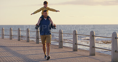 Buy stock photo Dad, son and shoulder carry at sea on holiday, adventure and outdoor for bonding with father. Boy, child and papa support with airplane game for freedom, promenade and ocean for love or fun on trip