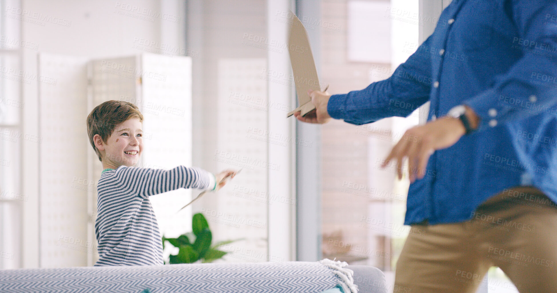 Buy stock photo Boy, dad and cardboard sword in home for fight, happy and playful with love, bonding and care in living room. Child, father and smile with toy weapon, fun and games with connection in family house