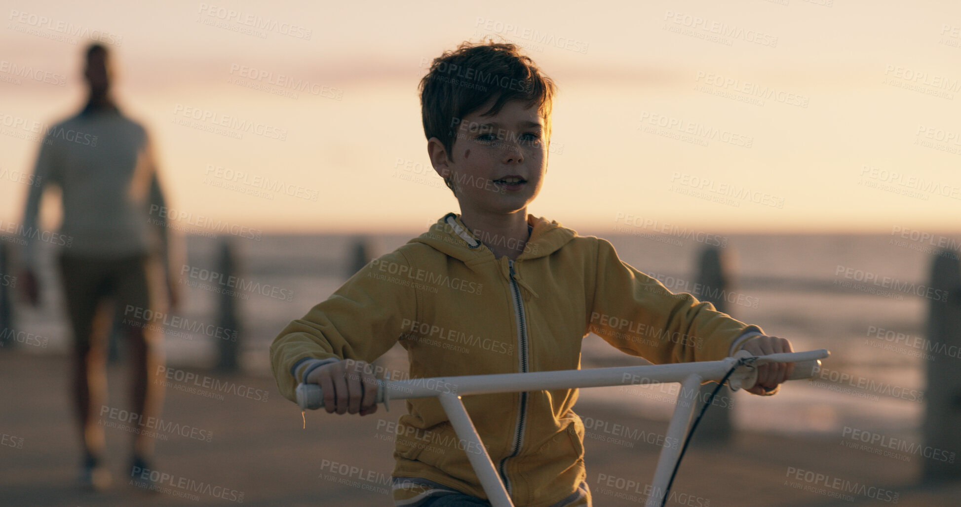 Buy stock photo Boy, child and bicycle at sunset, beach and promenade with dad, riding and happy on vacation in summer. Kid, father and bike with learning, adventure and playful with bonding by ocean in New Zealand