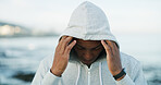Beach, fitness or black man with hoodie for workout, running and outdoor marathon training. Start, athlete runner or healthy person at sea for insulated fabric, thermal sportswear or exercise clothes