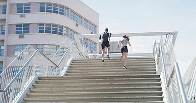 Buy stock photo Running, health and stairs with couple in city for personal trainer, fitness or team. Wellness, race and marathon training with back of people outdoor steps for workout, exercise and sports low angle