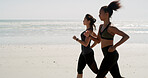 Fitness, women and running on beach for exercise, wellness and cardio training with space. Friends, runners and challenge at ocean for competitive endurance, healthy body and lose weight in Spain