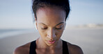 Fitness, woman and music on beach for workout, music and training podcast for endurance. Athlete, marathon and earphones at ocean with exercise, physical health and resilience at California seaside