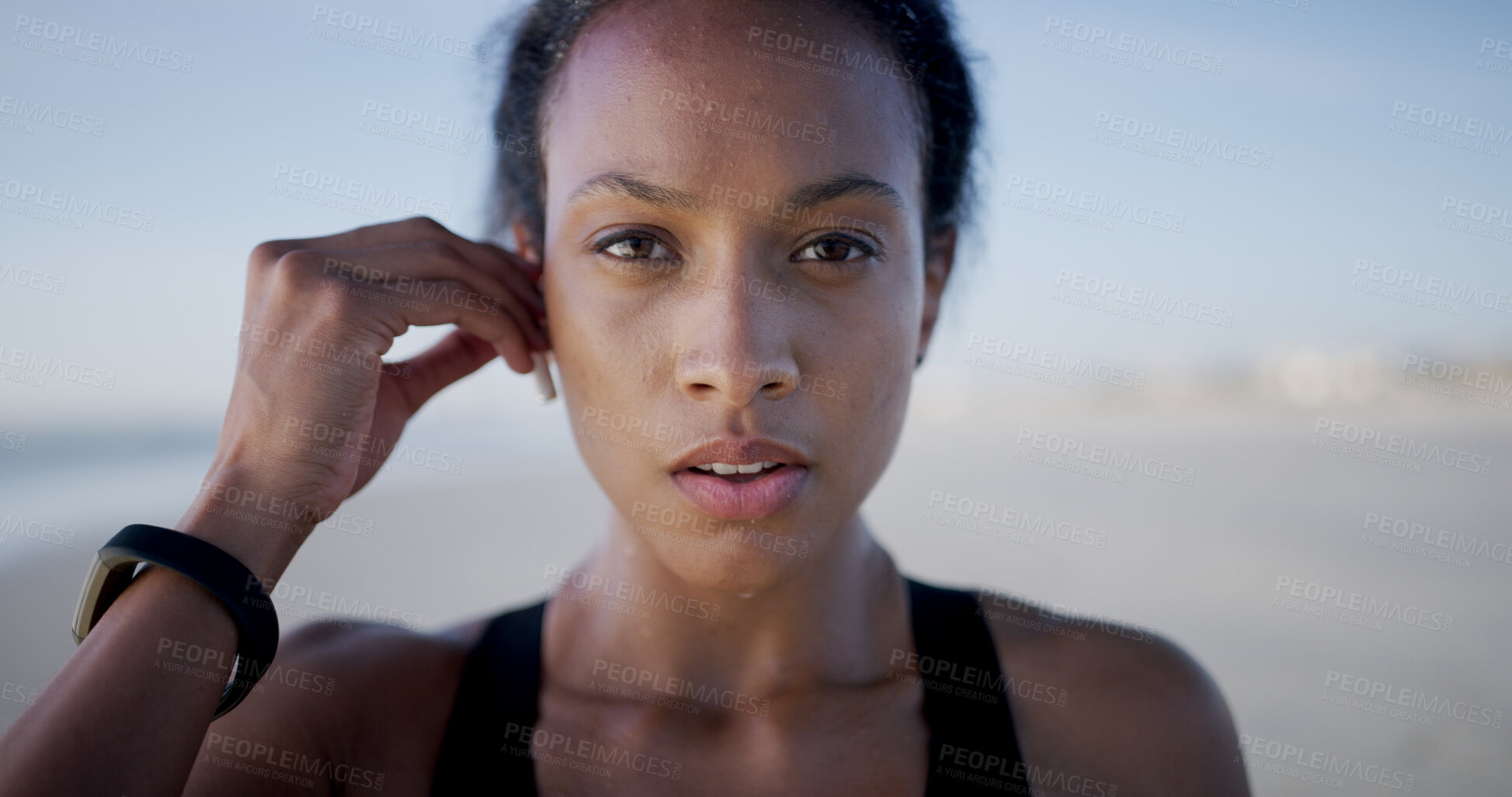 Buy stock photo Fitness, woman and portrait on beach for workout, music and training podcast for endurance. Athlete, marathon and earphones at ocean for exercise, physical health and resilience at California seaside