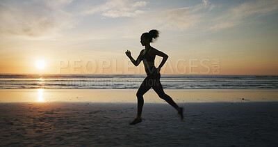 Buy stock photo Fitness, woman silhouette and running on beach for exercise, wellness and cardio training at sunset space. Girl, runner and speed challenge at ocean for marathon, healthy body and endurance in Spain