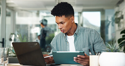 Buy stock photo Man, tablet and laptop at startup in office with reading, planning or insight for project at media company. Person, pc and review process with app, feedback and deadline for report at creative agency