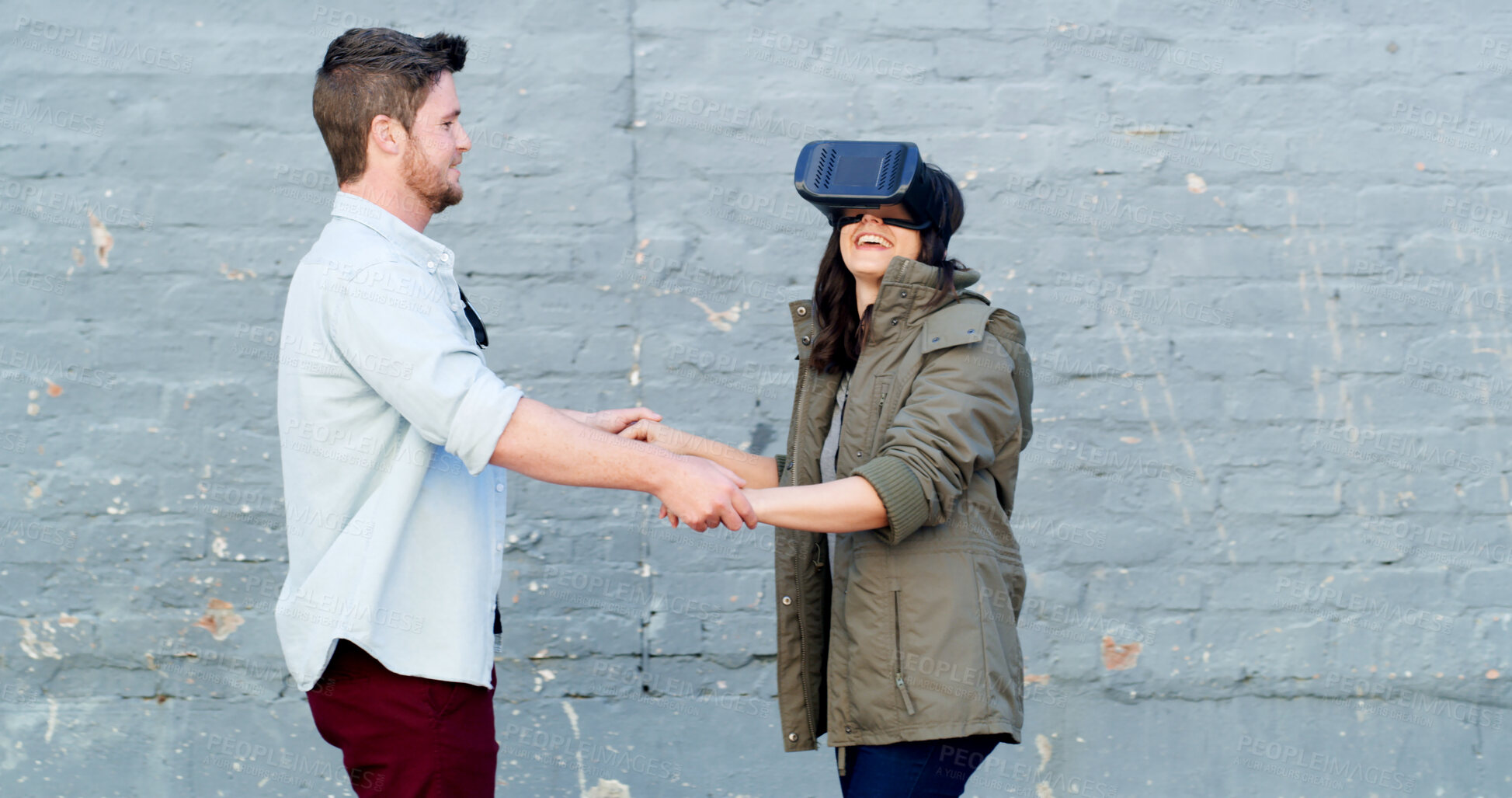 Buy stock photo Couple, virtual reality and headset in street with game, laugh or guide for rpg with futuristic tech in city. Woman, man and happy with holding hands, ar glasses or play in metaverse on road in Spain