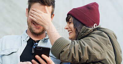 Buy stock photo Happy couple, surprise or cover eyes at phone for secret, social media trend or fun in city. Man, woman or outdoor with mobile for guessing game, announcement or trust in relationship at notification