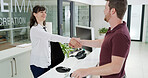 Happy, business people and handshake with meeting at front desk for greeting, introduction or hiring at office. Businessman, woman or employees shaking hands with smile for recruiting or information