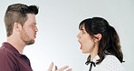 Angry couple, shouting and argument with disagreement for conflict, fight or dispute on a white studio background. Man, woman or screaming with anger for toxic relationship, affair or bad behaviour