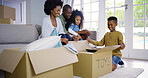 Happy, black family and unboxing toys with children for moving in new home together or relocation. African, mom and dad with excited kids for unpacking, property or package in living room at house