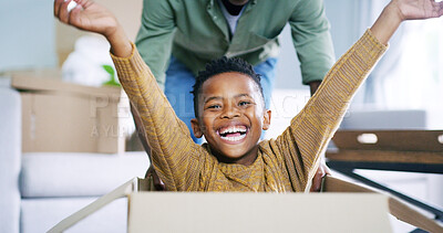 Buy stock photo Black child, portrait and boxes game with dad in new home, relocation fun and playing support. Son, father and pushing kid in cardboard for fantasy race in living room, happy energy and moving house