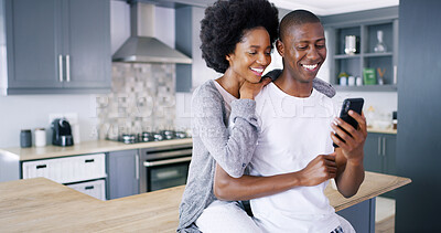 Buy stock photo Black couple, mobile and love in kitchen with social media, ecommerce and funny video on internet. Happy man, woman and phone in home for relax, good news and hug on counter with streaming platform