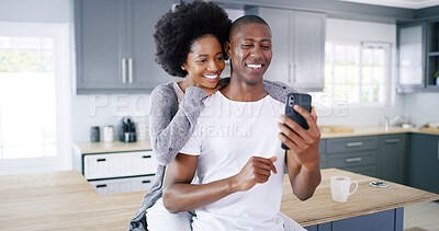 Buy stock photo Black couple, phone and love in kitchen with social media, subscription or funny video on internet. Happy man, woman and mobile in home for relax, good news and hug on counter with streaming platform